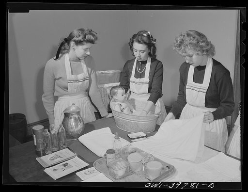 Washington, D.C. Home economics students at Woodrow Wilson High School learning baby care practicing with a large doll