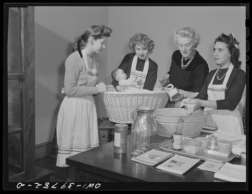 Washington, D.C. Home economics students at Woodrow Wilson High School learning baby care practicing with a large doll