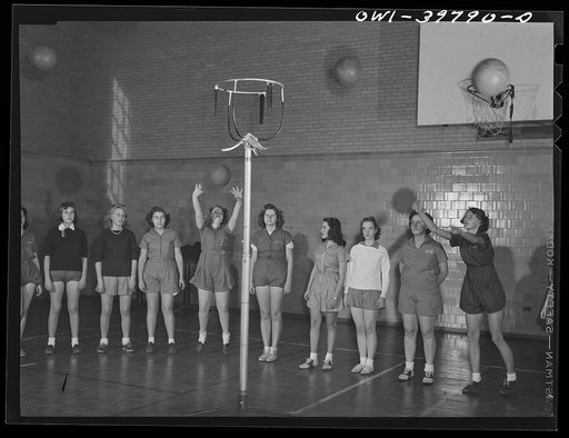 Washington, D.C. Members of a girls' physical education class practicing basketball at Woodrow Wilson High School