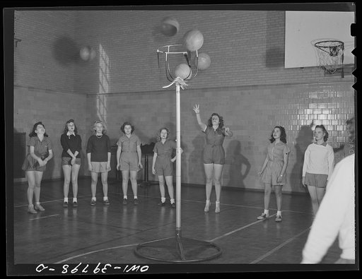 Washington, D.C. Members of a girls' physical education class practicing basketball at Woodrow Wilson High School