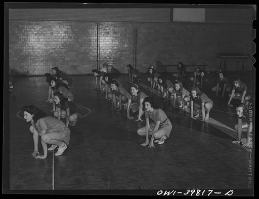 Washington, D.C. Physical education class doing mass exercises in the gymnasium at Woodrow Wilson High School