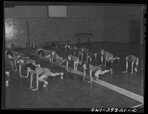 Washington, D.C. Physical education class doing mass exercises in the gymnasium at Woodrow Wilson High School
