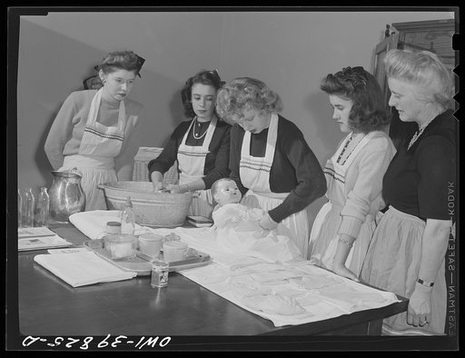 Washington, D.C. Home economics students at Woodrow Wilson High School learning baby care practicing with a large doll