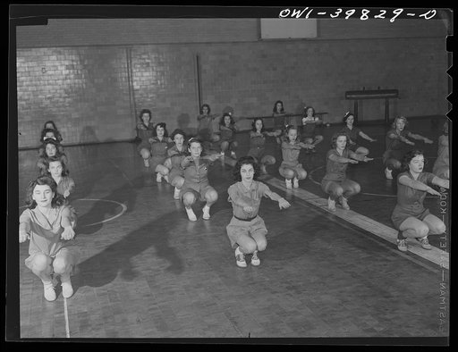 Washington, D.C. Physical education class doing mass exercises in the gymnasium at Woodrow Wilson High School
