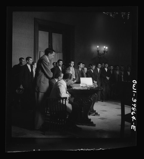 Sicilian civilians being tried in a court composed of two American majors and one Royal Air Force squadron leader. They were charged with starting a riot which resulted in the death of several townsfolk