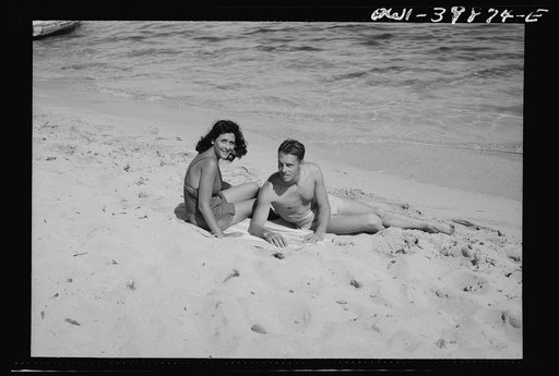 A young couple on the beach in Sicily. The people are gradually returning to normal recreations