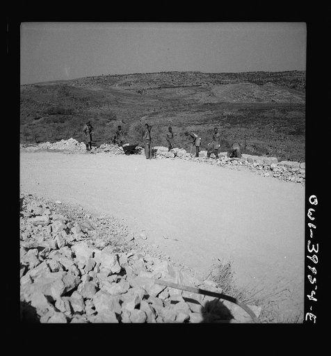 Repairing Sicilian roads demolished by the Germans in retreat