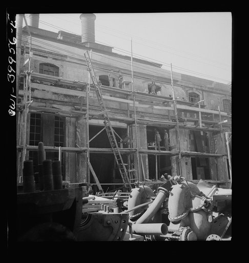Catania, Sicily. Rebuilding the city. The Allied government is paying a wage comparable with peacetime for the labor. This money is charged to the Italian government, which will return it later