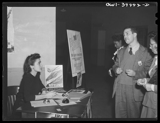 Untitled photo, possibly related to: Washington, D.C. The registration desk during a drive for blood donors sponsored by Local 203 of the United Federal Workers of America, Congress of Industrial Organizations (CIO), and the personnel division of the United States Office of War Information (OWI)