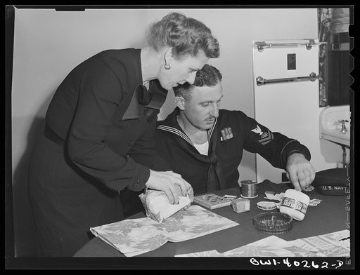 Washington, D.C. A sailor getting some help in wrapping his Christmas gifts at the United Nations service center