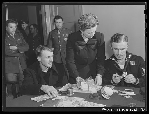 Washington, D.C. A sailor getting some help in wrapping his Christmas gifts at the United Nations service center