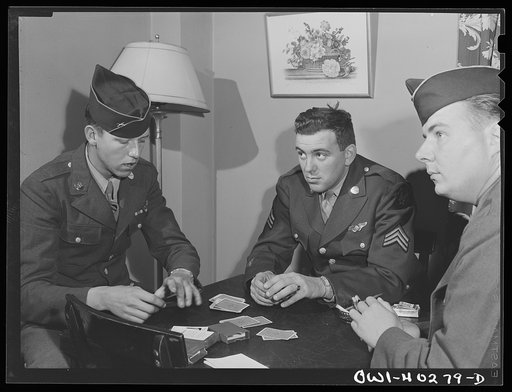 Washington, D.C. Soldiers waiting between trains playing cards in the game room at the United Nations service center