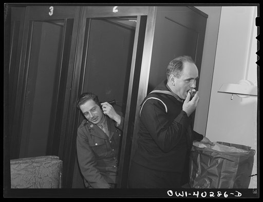 Washington, D.C. Sampling a basket of apples, which was given to servicemen by the telephone company on Thanksgiving Day, at the United Nations service center