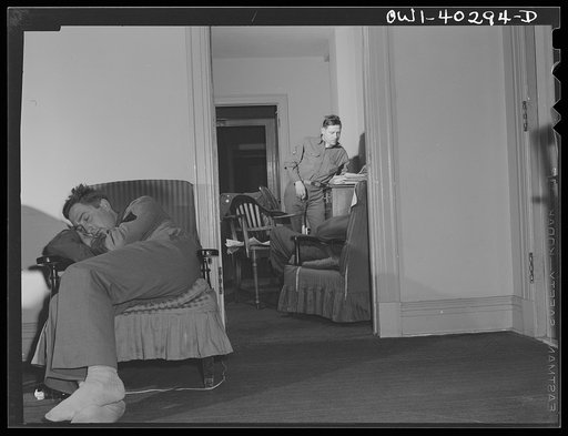 Washington, D.C. Servicemen who must wait several hours between trains sleeping in one of the lounges at the United Nations service center