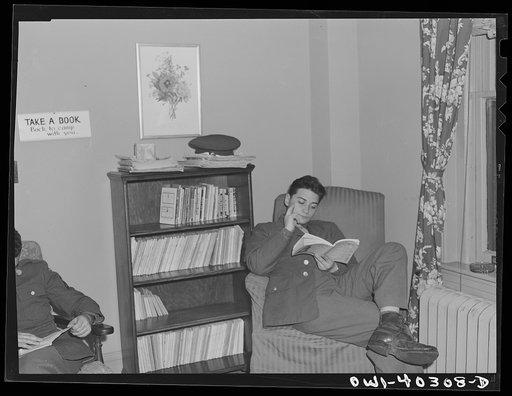Untitled photo, possibly related to: Washington, D.C. In the library at the United Nations service center. Boys are urged to take books back to camp with them