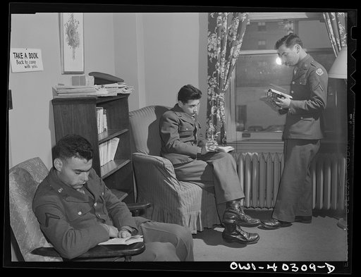 Washington, D.C. In the library at the United Nations service center. Boys are urged to take books back to camp with them