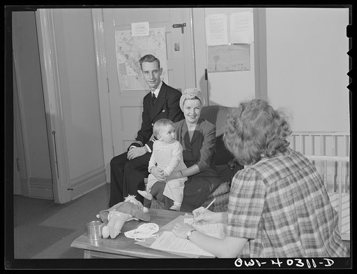 Washington, D.C. A naval officer and his wife leaving instructions for the care of their child whom they are leaving in the nursery of the United Nations service center while they wait between trains