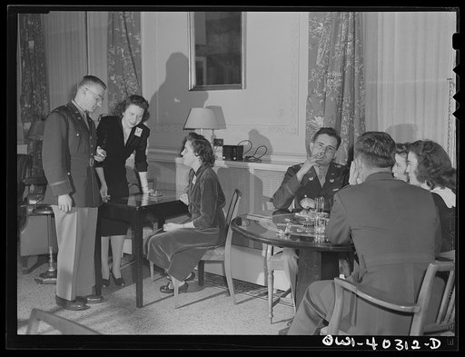 Washington, D.C. In the officers' lounge at the United Nations service center, a hostess introduces a young officer to one of the volunteer hostesses