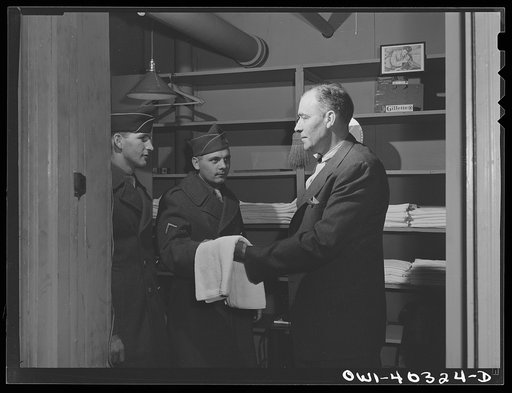 Untitled photo, possibly related to: Washington, D.C. Attendant at the United Nations service center who furnishes soap, towels, and razors to boys who wish to clean up between trains or when they arrive in town