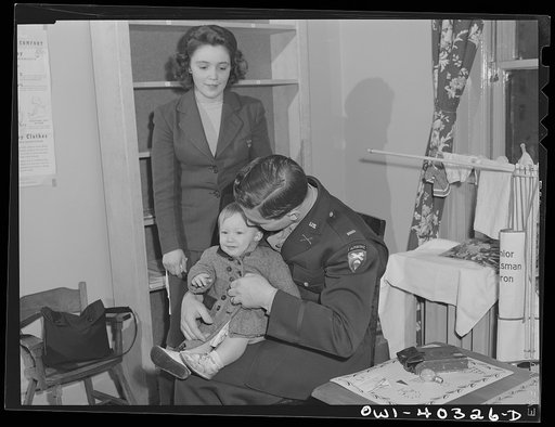 Washington, D.C. A young couple picking up their child who was taken care of in the nursery at the United Nations service center while they spent the day shopping