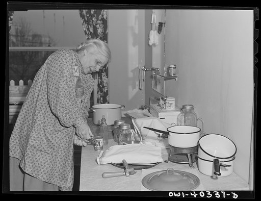 Washington, D.C. A volunteer worker opening a can of baby food for a child who is being cared for at the United Nations service center