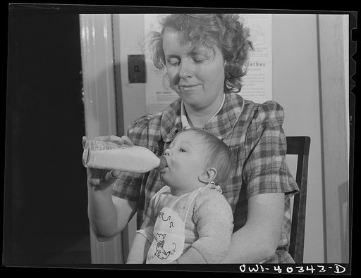 Washington, D.C. Child being fed at the nursery in the United Nations service center