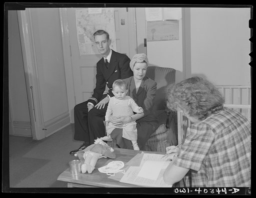 Untitled photo, possibly related to: Washington, D.C. A naval officer and his wife leaving instructions for the care of their child whom they are leaving in the nursery of the United Nations service center while they wait between trains