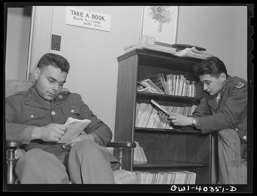 Washington, D.C. In the library at the United Nations service center. Boys are urged to take books back to camp with them