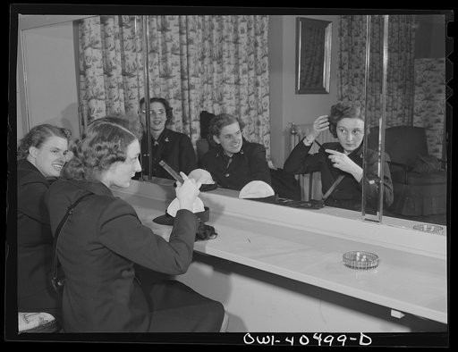 Washington, D.C. A group of WAVES (Women Accepted for Volunteer Emergency Service), just off a train, freshen up in the powder room at the United Nations service center