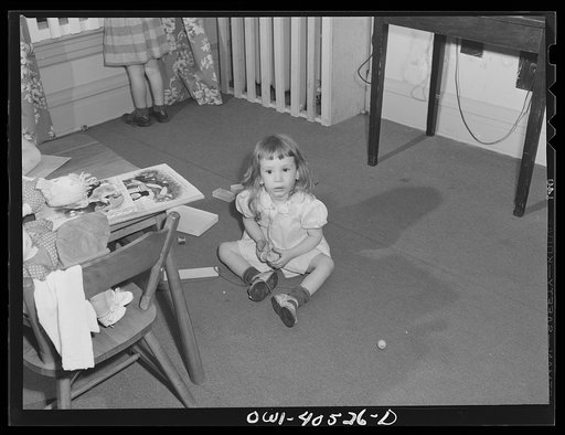Washington, D.C. Children playing in the nursery at the United Nations service center while their mother makes arrangements for continuing their journey