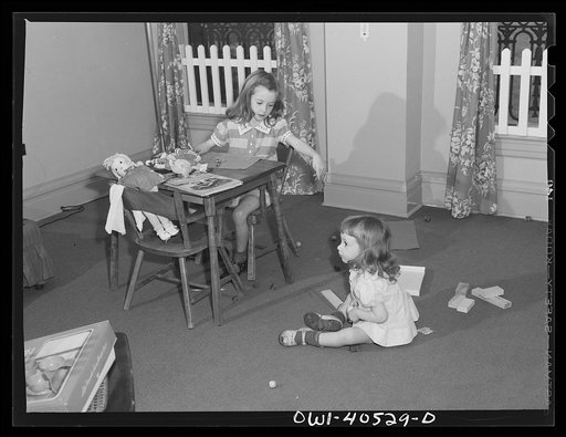 Washington, D.C. Children playing in the nursery at the United Nations service center while their mother makes arrangements for continuing their journey