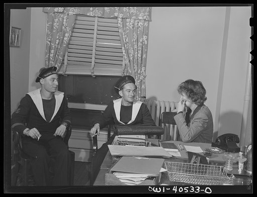 Washington, D.C. Two French sailors who missed their train explain their plight to a French-speaking volunteer at the United Nations service center and are set on the right course