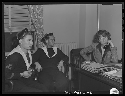 Washington, D.C. Two French sailors who missed their train explain their plight to a French-speaking volunteer at the United Nations service center and are set on the right course