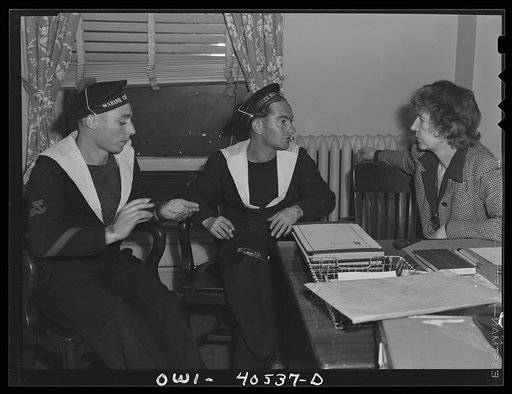 Washington, D.C. Two French sailors who missed their train explain their plight to a French-speaking volunteer at the United Nations service center and are set on the right course