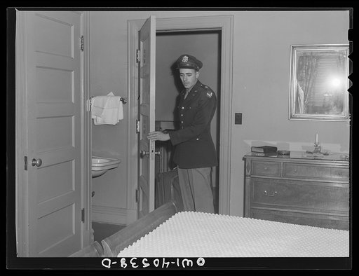 Untitled photo, possibly related to: Washington, D.C. A lieutenant in the United States Army Air Transport Command calling the airport to check on flight conditions before checking out at the United Nations service center