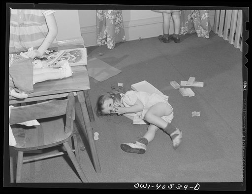 Washington, D.C. Children playing in the nursery at the United Nations service center while their mother makes arrangements for continuing their journey