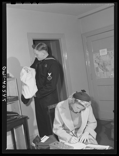 Untitled photo, possibly related to: Washington, D.C. Lynn and Hugh Massman filling out the information blanks required before leaving their son at the United Nations service center nursery