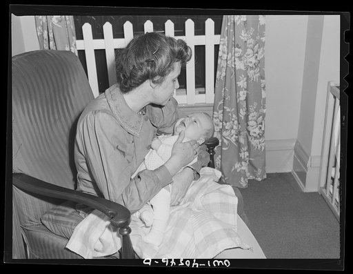 Washington, D.C. A volunteer holding Joey Massman, whose parents have left him in the nursery at the United Nations service center while they go sightseeing