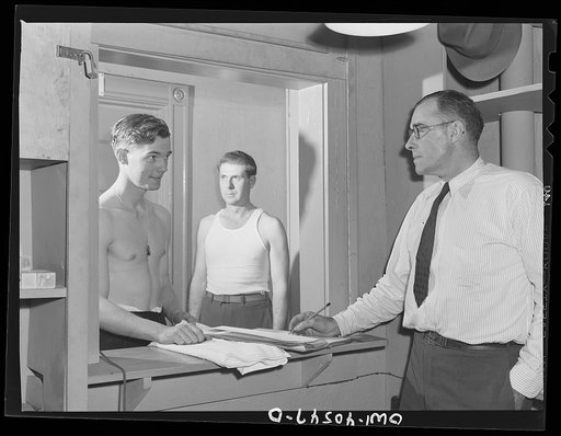 Washington, D.C. Servicemen getting towels and soap from an attendant in the enlisted men's shower room at the United Nations service center