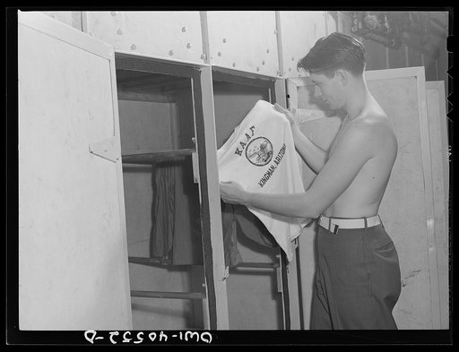 Washington, D.C. A soldier in the laundry at the United Nations service center taking his shirt out of the electric dryer which dries clothes in thirty minutes