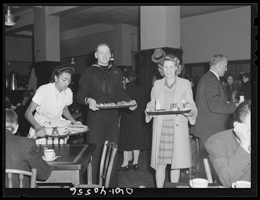 Washington, D.C. Hugh and Lynn Massman eating lunch at a cafeteria after a day of sightseeing. Their eight-weeks-old son is being taken care of at the United Nations service center