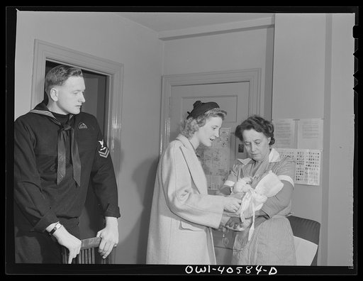 Washington, D.C. Lynn Massman giving instructions to the volunteer worker at the nursery in the United Nations service center who will take care of her eight-weeks-old baby for the day