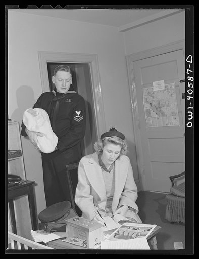 Washington, D.C. Lynn and Hugh Massman filling out the information blanks required before leaving their son at the United Nations service center nursery