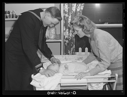 Washington, D.C. Hugh and Lynn Massman preparing to take their son from the nursery at the United Nations Service Center