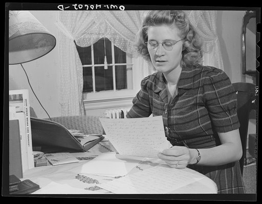 Washington, D.C. Lynn Massman, wife of a second class petty officer who is studying in Washington, writing letters while her baby is having his afternoon nap