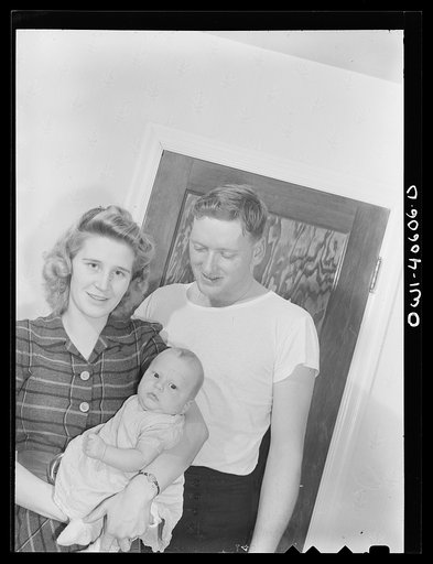 Untitled photo, possibly related to: Washington, D.C. Hugh Massman, a second class petty officer who is studying in Washington, and his wife eating dinner. Joey, their son, sleeps on a pad on the table
