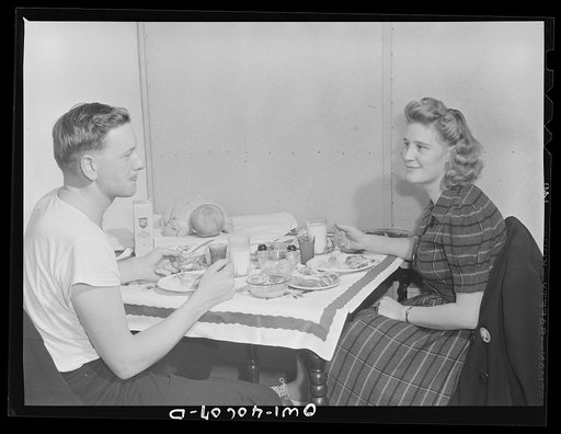Washington, D.C. Hugh Massman, a second class petty officer who is studying in Washington, and his wife eating dinner. Joey, their son, sleeps on a pad on the table