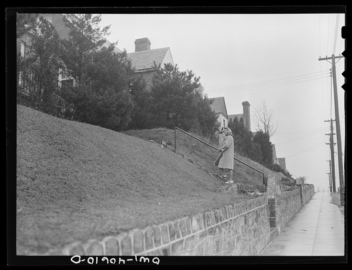 Washington, D.C. Lynn Massman, wife of a second class petty officer who is studying in Washington, coming home from the grocery store. While Lynn shops, her landlady keeps an eye on baby Joey