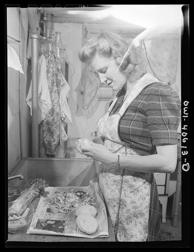 Untitled photo, possibly related to: Washington, D.C. Lynn Massman, wife of a second class petty officer who is studying in Washington, preparing dinner
