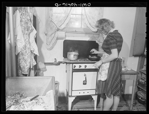 Washington, D.C. Lynn Massman, wife of a second class petty officer who is studying in Washington, cooking dinner